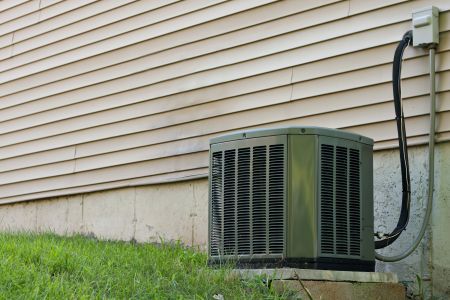 Clean outdoor condenser unit after professional air conditioner maintenance