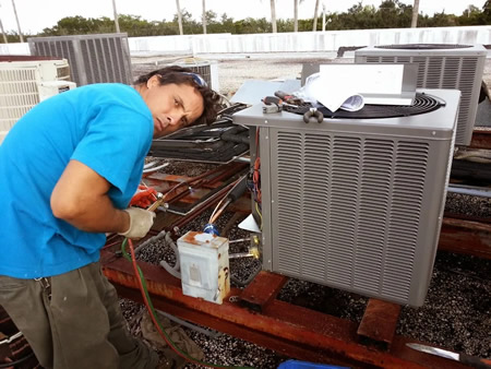 Technician performing ac tune up in delray beach fl home